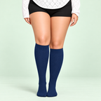 Blue bamboo compression socks, standing front view on a pale sage background