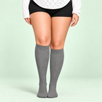 Gray bamboo compression socks, standing front view on a pale sage background